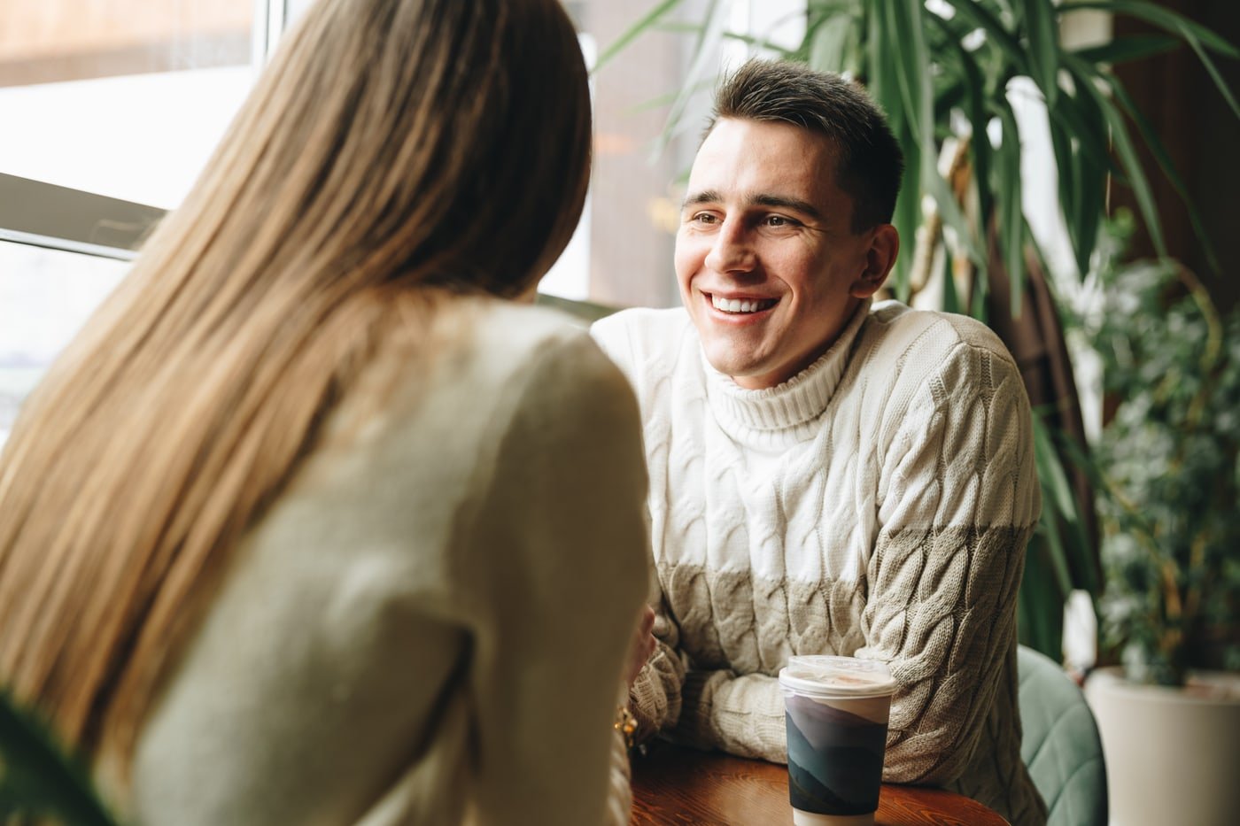 Man and woman speaking across a table during an immigration consultation