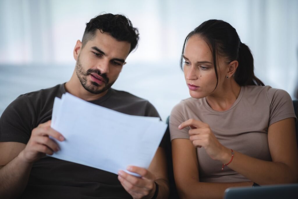 Man and woman reviewing immigration paperwork together during a consultation